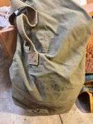 Boxes of rags, military bag, and blankets