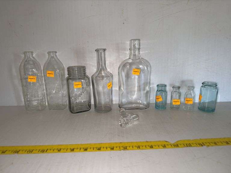 Assortment of Glass Bottles and Decanter Lids