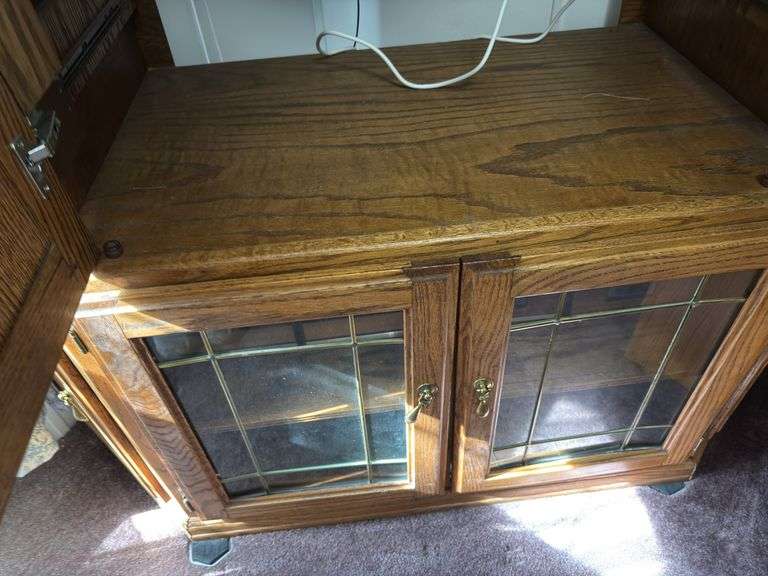 Corner Entertainment Center has cracked glass pane