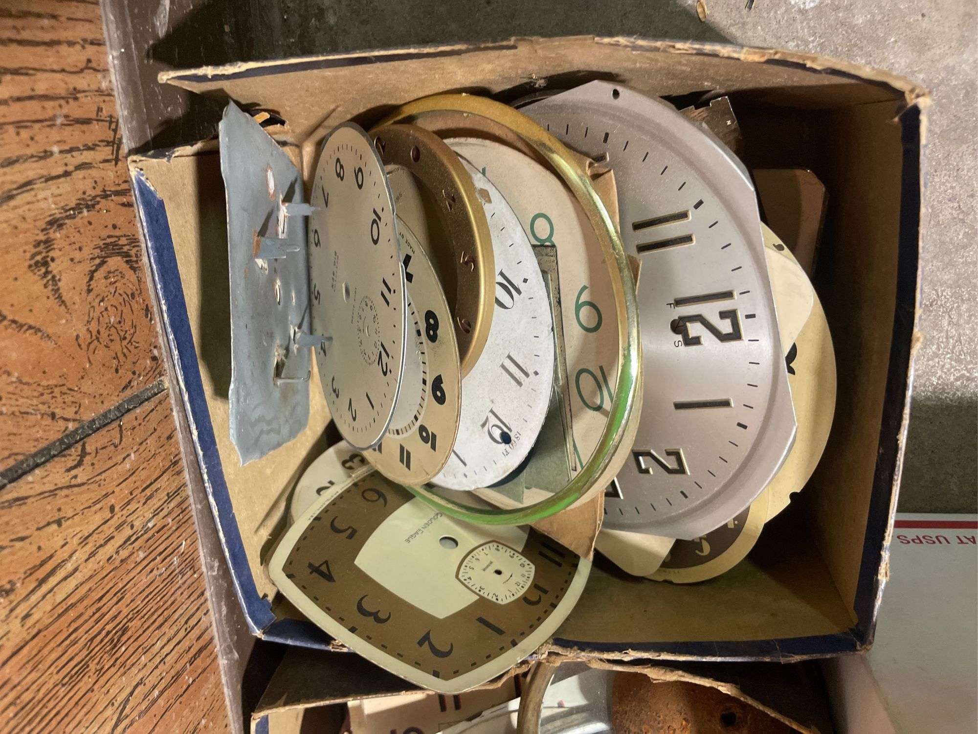 Assortment of clock parts including clock faces, movements & more ...