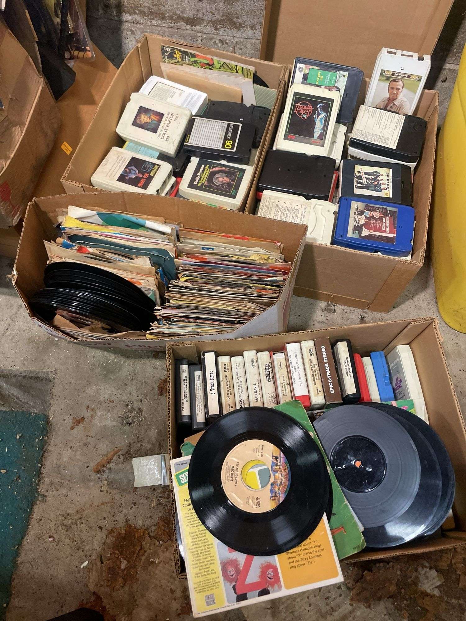 (2) boxes of 8 tracks and (2) boxes of records