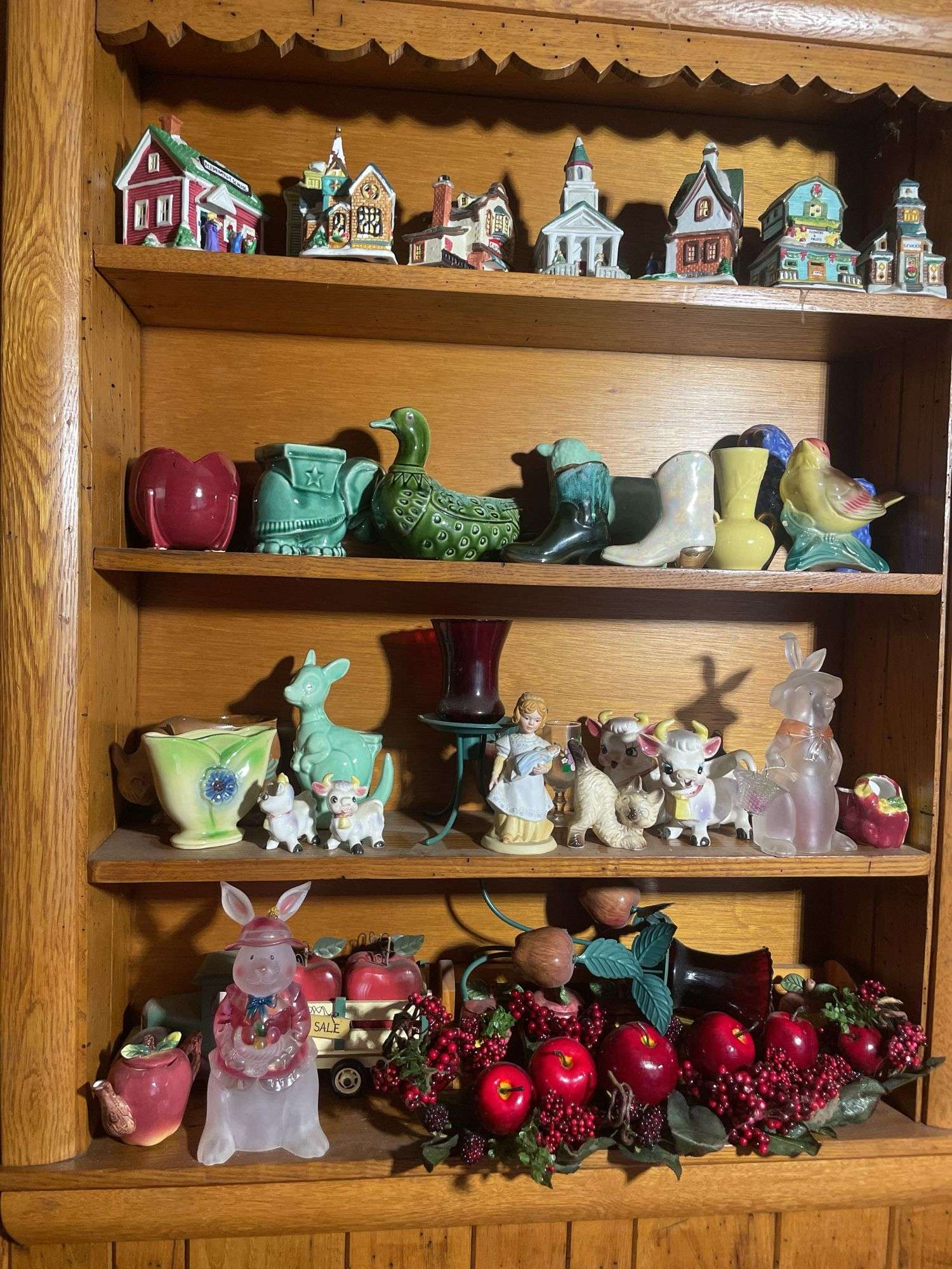 Contents of shelving including decorative Christmas buildings, ceramic planters, figurines & decor