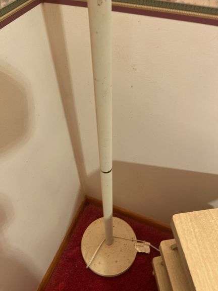 Wooden chair on wheels, small stand and floor lamp