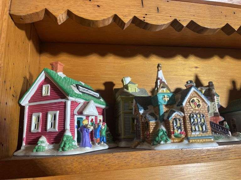 Contents of shelving including decorative Christmas buildings, ceramic planters, figurines & decor