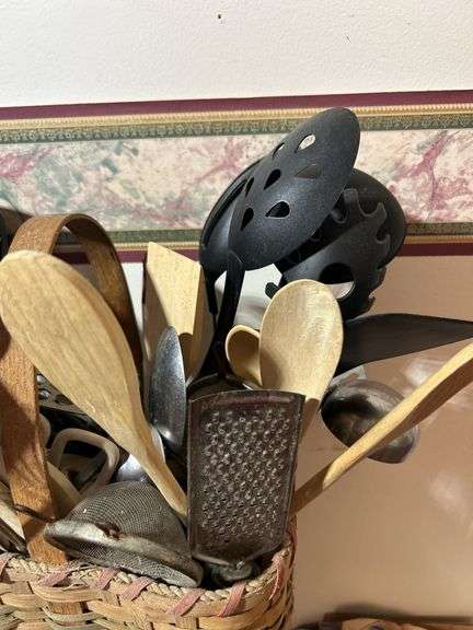 Basket with kitchen gadgets/kitchen utensils including spoons, scissors, spoons forks and more