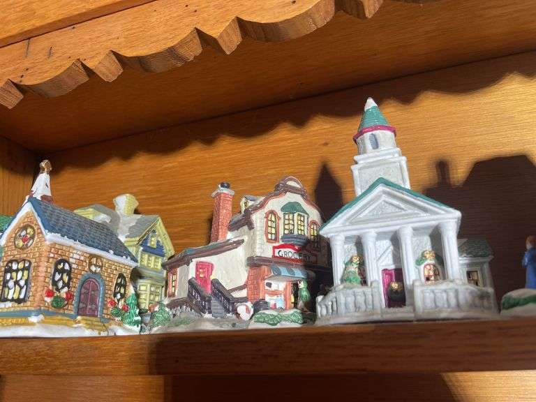Contents of shelving including decorative Christmas buildings, ceramic planters, figurines & decor
