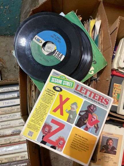 (2) boxes of 8 tracks and (2) boxes of records