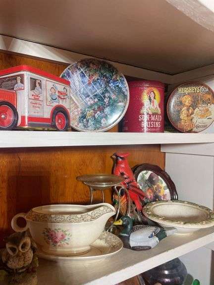 Contents of 2 shelves - including tins, decorative glassware, wooden wagon & more
