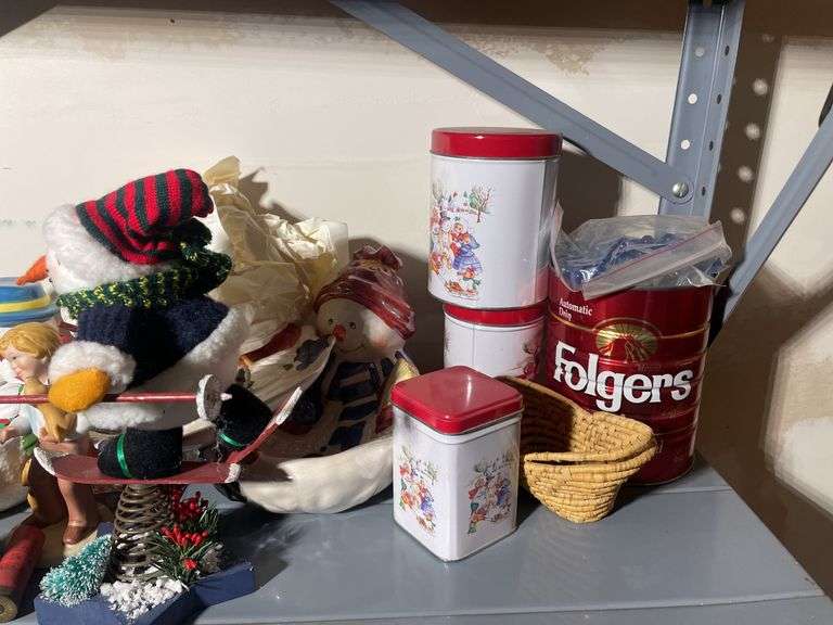 Metal shelf with Christmas decor including decorative sleigh, figurines, stuffing and more