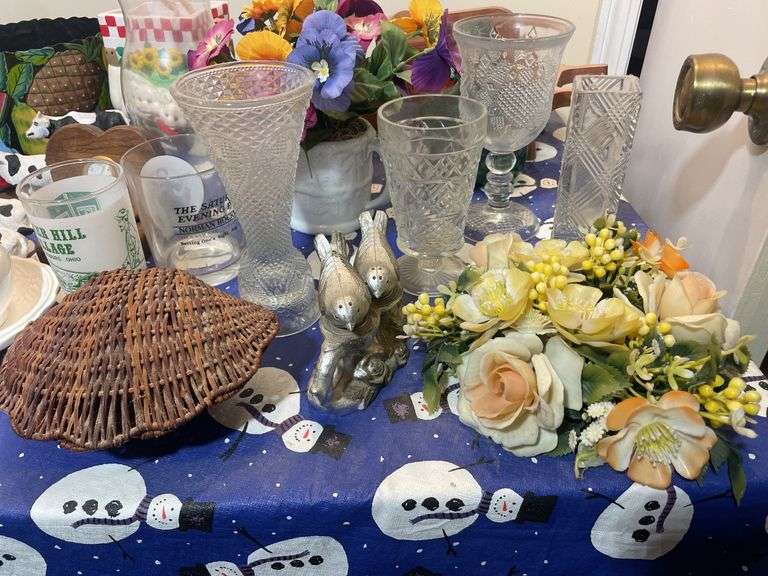 Large lot of glassware & household decor including pitcher, drinking glasses, old baby shoes and mor