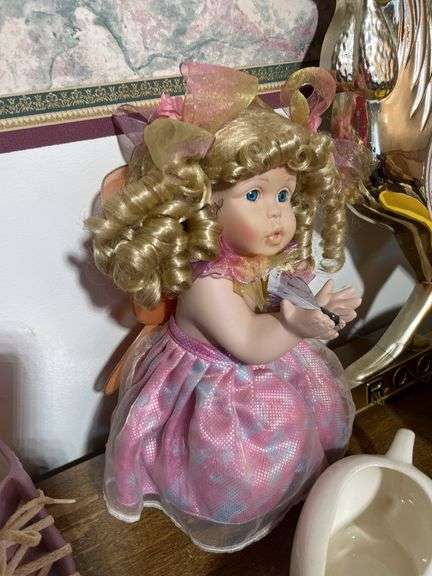 Box of decorative items including rooster clock, butterfly wall hanger, soap dispenser, kitchen item
