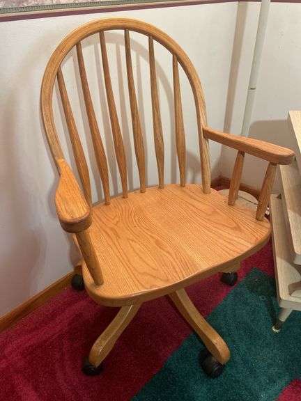 Wooden chair on wheels, small stand and floor lamp