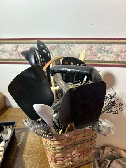 Basket with kitchen gadgets/kitchen utensils including spoons, scissors, spoons forks and more