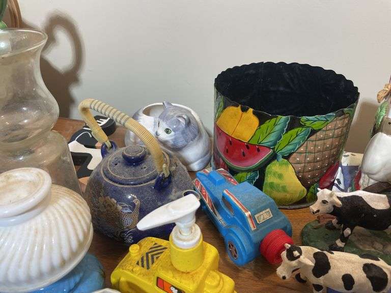 Large lot of glassware & household decor including pitcher, drinking glasses, old baby shoes and mor