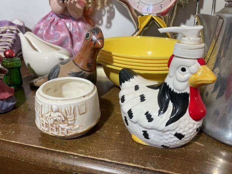 Box of decorative items including rooster clock, butterfly wall hanger, soap dispenser, kitchen item