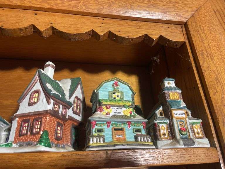 Contents of shelving including decorative Christmas buildings, ceramic planters, figurines & decor