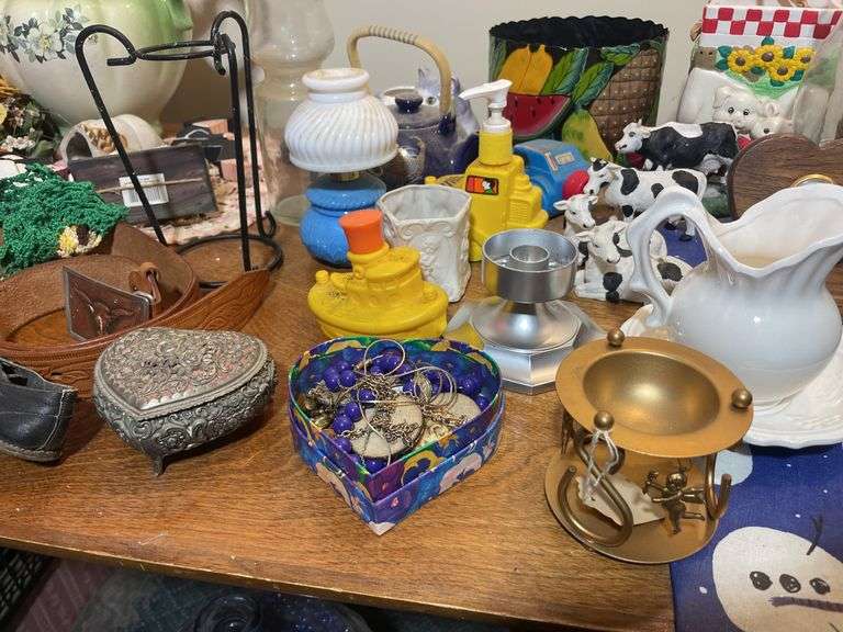 Large lot of glassware & household decor including pitcher, drinking glasses, old baby shoes and mor