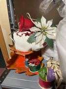 Metal shelf with Christmas decor including decorative sleigh, figurines, stuffing and more