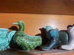 Contents of shelving including decorative Christmas buildings, ceramic planters, figurines & decor