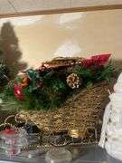 Metal shelf with Christmas decor including decorative sleigh, figurines, stuffing and more