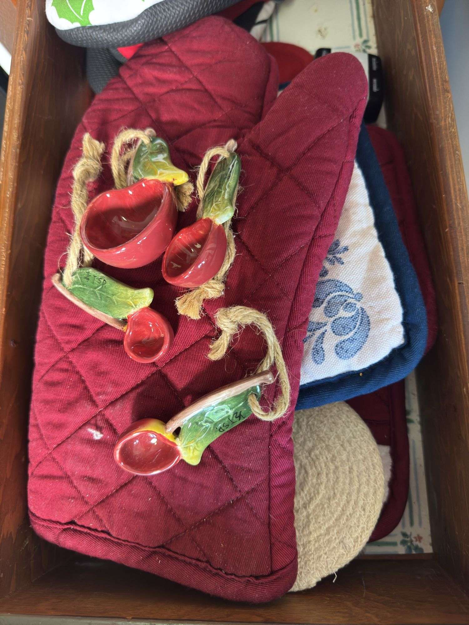 CONTENTS OF DRAWER OVEN MITTS, MEASURING SPOONS
