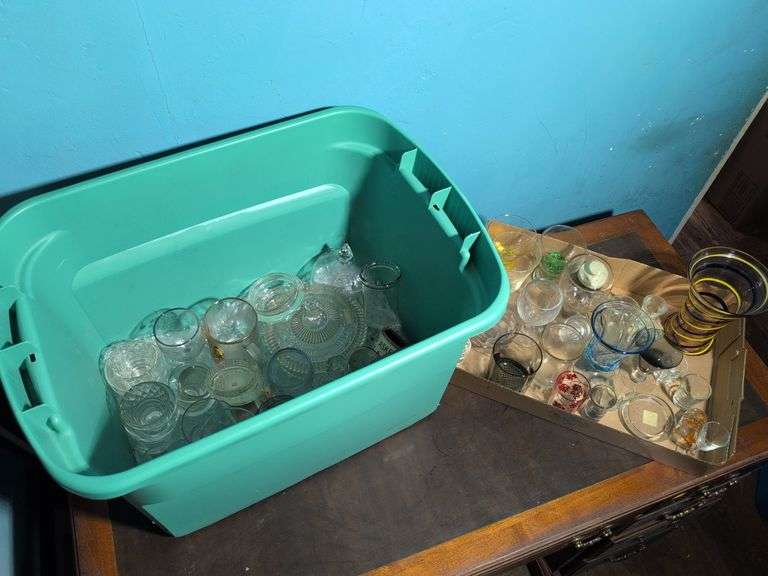 Assortment of glassware - cups, shot glasses, mugs, vases, and more