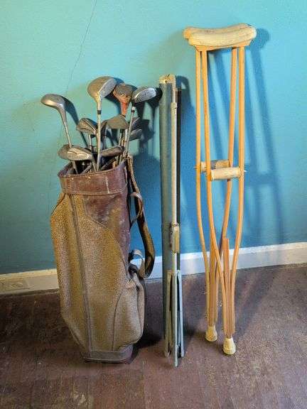 Antique golf clubs and bag, projector screen, and crutches