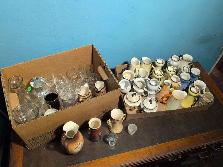 Assortment of shot glasses, vases, pitchers, mugs, and more