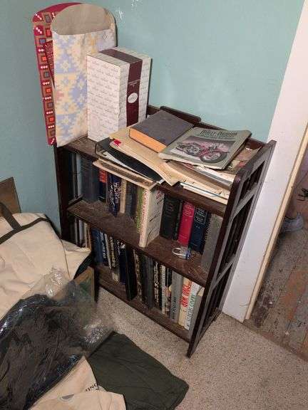 Bookshelf with contents - books, lock and key, magazines, and more