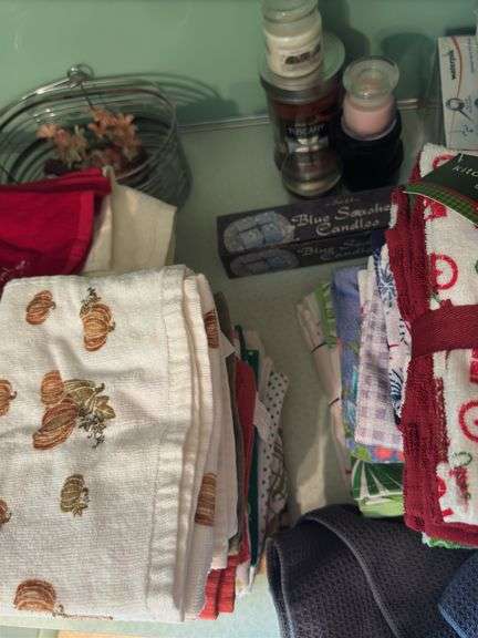 CONTENTS OF COUNTER TOP, TEA TOWELS (SOME NEW), CANDLES,