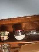 CONTENTS OF CABINET VINTAGE FLOUR SIFTER, SERVING BOWLS, MEASURING CUPS, FOOD SCALES