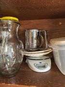CONTENTS OF CABINET VINTAGE FLOUR SIFTER, SERVING BOWLS, MEASURING CUPS, FOOD SCALES