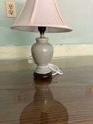 ROUND MDF-TOP TABLE WITH CONTENTS TABLE CLOTH, GLASSWARE, FLORAL DECOR, LAMPS, (ITEMS IN PHOTOS)
