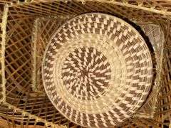 WOVEN BASKETS, POLAROID CAMERA WITH INSTANT FILM, AND PANASONIC LUMIX CAMERA