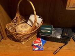WOVEN BASKETS, POLAROID CAMERA WITH INSTANT FILM, AND PANASONIC LUMIX CAMERA
