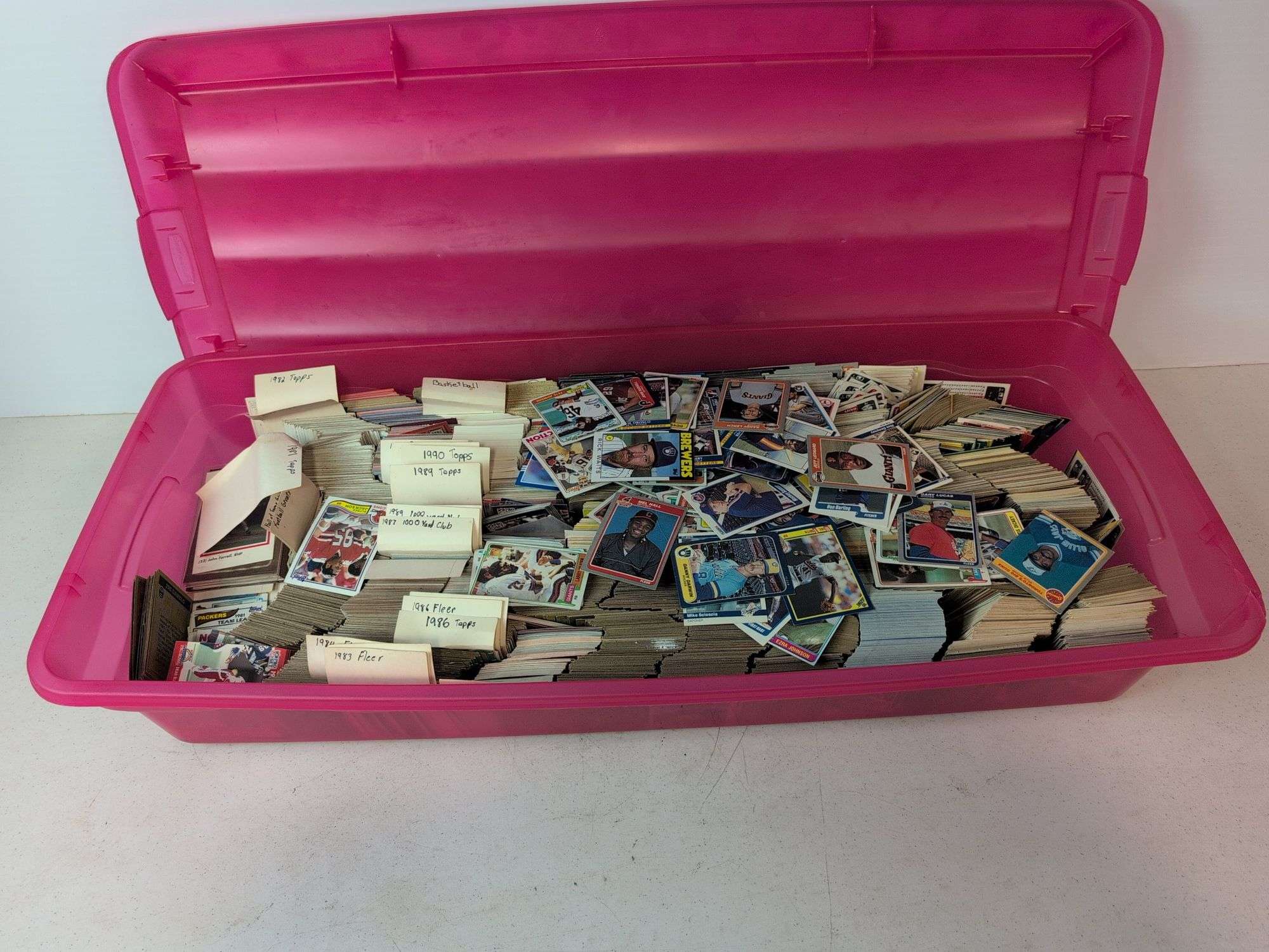Tote full of 80s and 90s baseball, football, and basketball cards