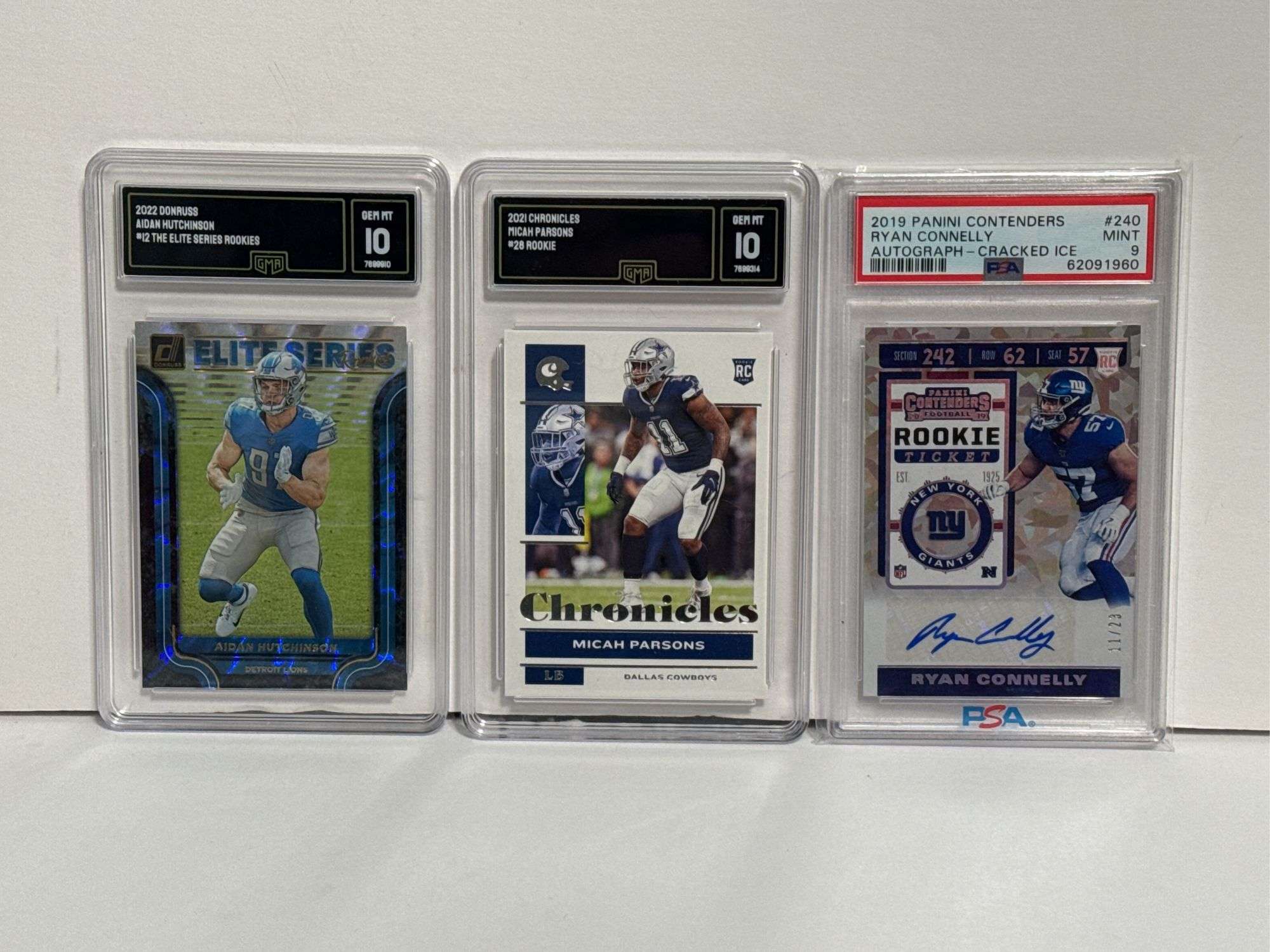 2022 Donruss Aidan Hutchinson “Elite Series” RC (GMA 10), 2021 Chronicles Micah Parsons RC (GMA 10),