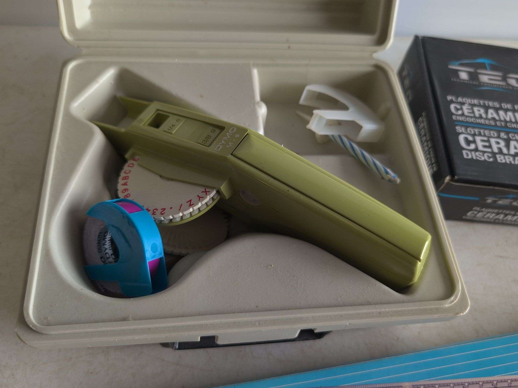 Dymo label maker kit, rolling ruler, and ceramic disc brake pads