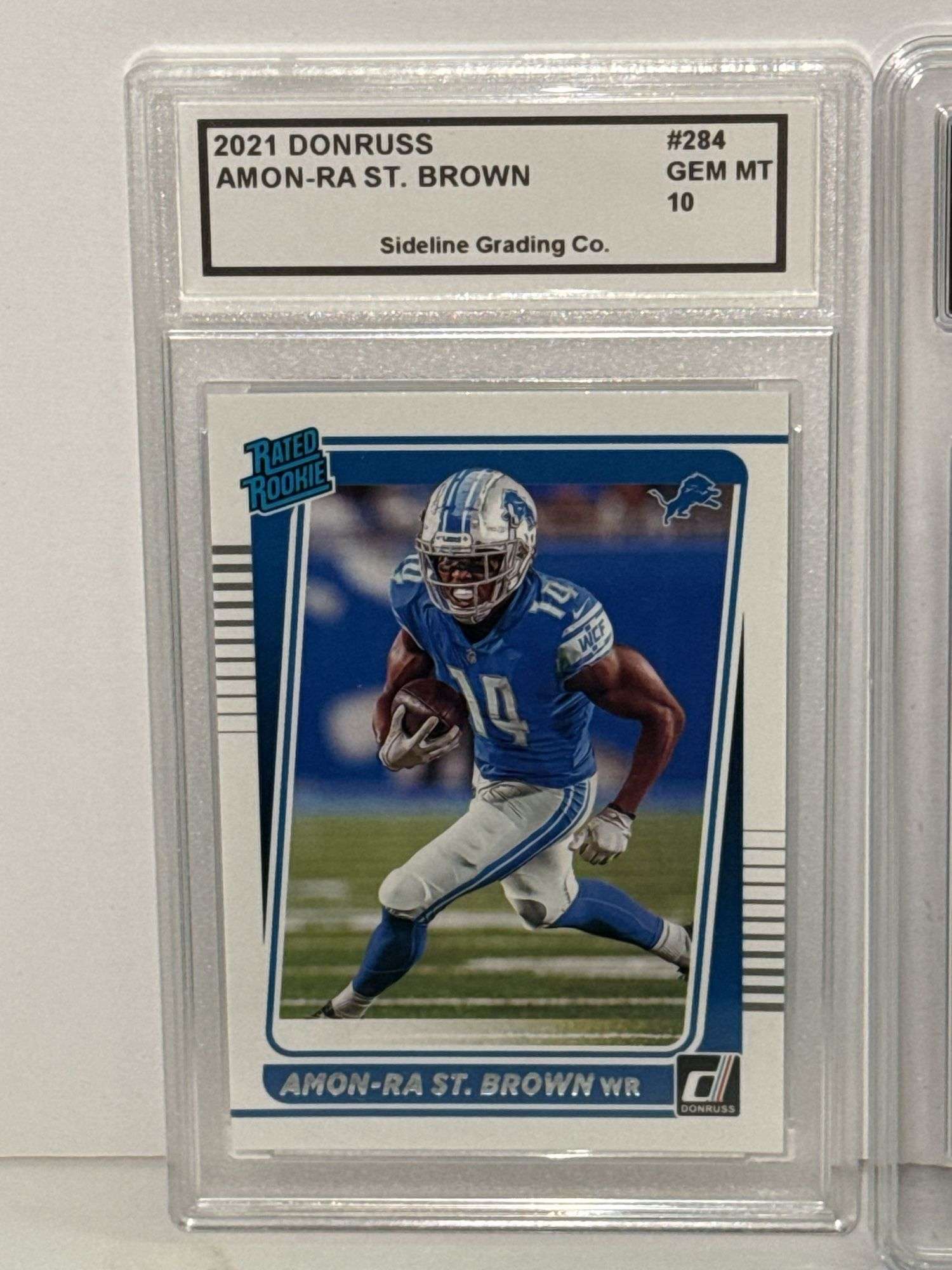 2021 Donruss Rated Rooke Amon-Ra St. Brown (SGC 10) and 2023 Select Sam LaPorta Concourse Rookie (GM