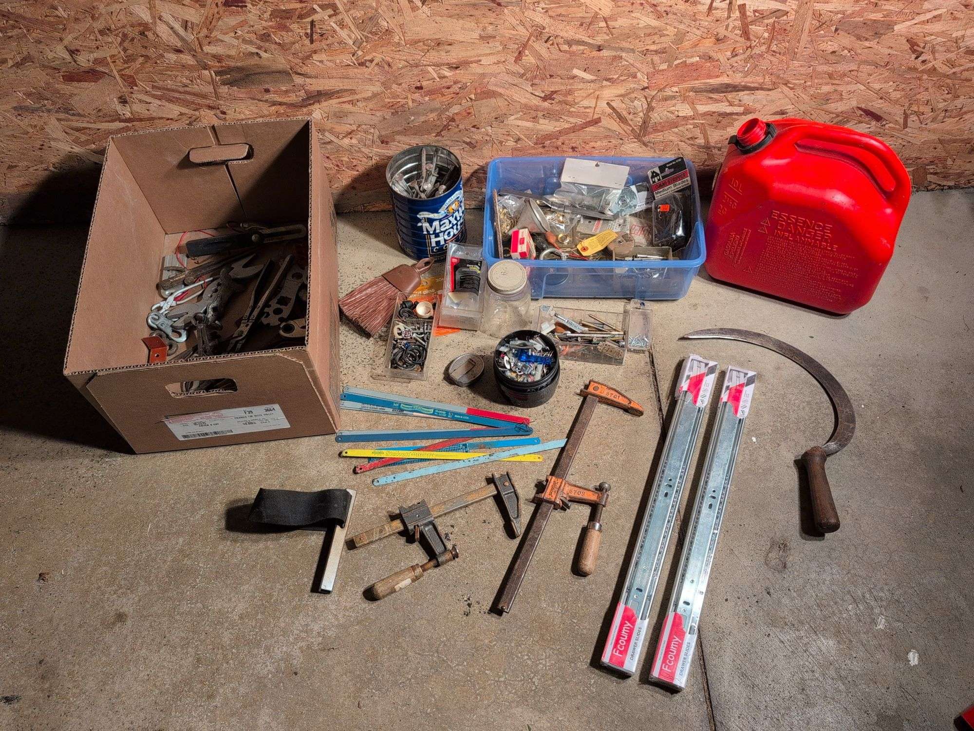 Miscellaneous tools and hardware - gas can, clamps, scythe, railroad nails, hacksaw blades, and more