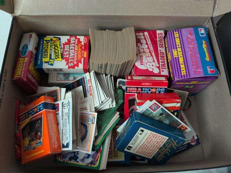 Football, baseball, and basketball trading cards with extra binder sleeves