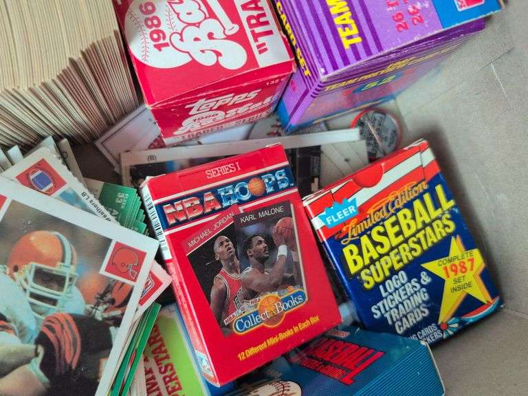 Football, baseball, and basketball trading cards with extra binder sleeves