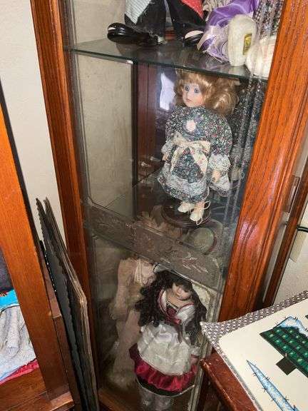 BOOKSHELF AND GLASS SHOWCASE W/ALL DOLLS. BLANKETS, AND FABRIC REMNANTS