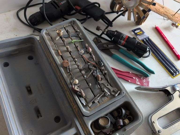 Black and Decker drill, Dremel and accessories, saw, staple gun, other tools, and model airplane