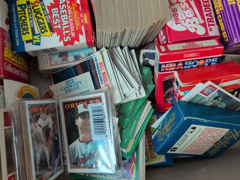 Football, baseball, and basketball trading cards with extra binder sleeves