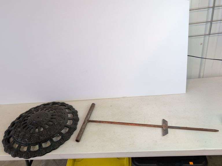 Large cast iron decorative piece and t-handled tool