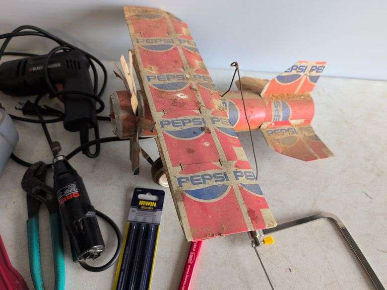 Black and Decker drill, Dremel and accessories, saw, staple gun, other tools, and model airplane