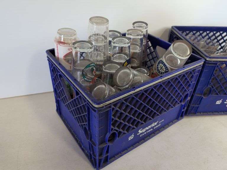 Bar glasses with sports logos in (2) milk crates