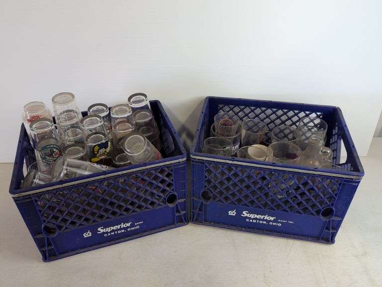 Bar glasses with sports logos in (2) milk crates