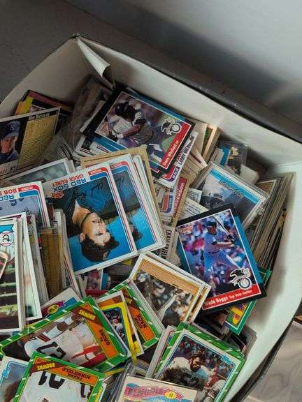 Football, baseball, and basketball trading cards with extra binder sleeves
